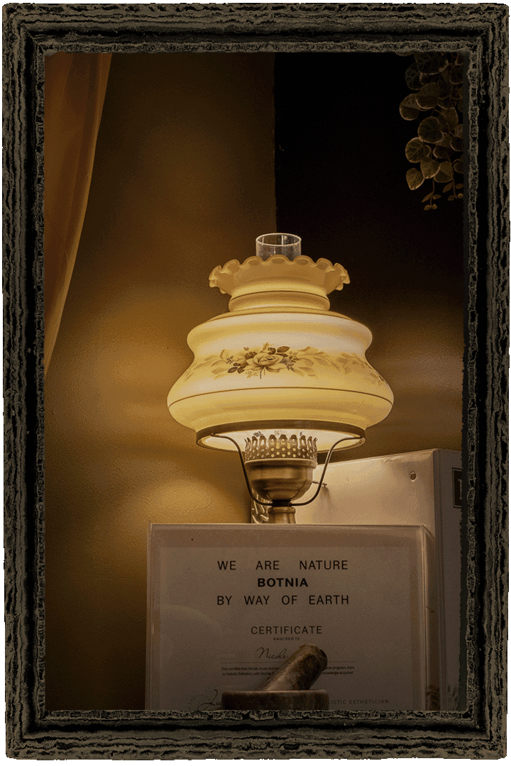 Vintage oil lamp above the Botnia certificate, in an antique frame